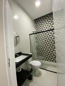 a bathroom with a toilet and a sink and a shower at Sol do Caribe Suítes in Maragogi