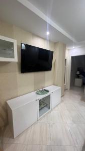 a living room with a flat screen tv on a wall at Bonito apartamento en Barrio Calvo Sotelo in Melilla