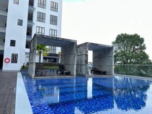 a swimming pool in front of a building at Wanderlust Homes @ Armadale Residence in Kuching