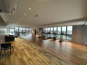 a gym with treadmills and exercise equipment in a building at Wanderlust Homes @ Armadale Residence in Kuching