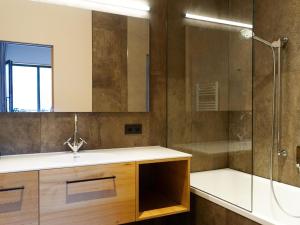 a bathroom with a sink and a shower at Apartment in Schröcken near Ski Arlberg in Schröcken +20 photos