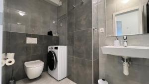 a bathroom with a toilet and a sink at Air conditioned 1 room Apartment Vienna Gate, 2 in Bratislava