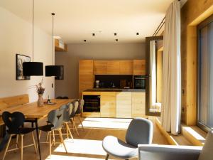 a kitchen and dining room with a table and chairs at Apartment in Schröcken near Ski Arlberg in Schröcken +17 photos