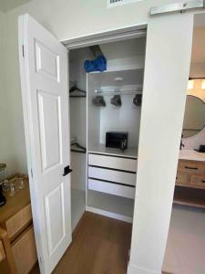 an open door to a closet with shoes in it at Location, location, location! 10 steps to the beach in San Diego