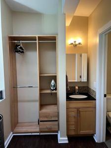 a bathroom with a sink and a mirror at Affordable & Chic RiNo/LoDo/Dtown Loft- Walkable in Denver