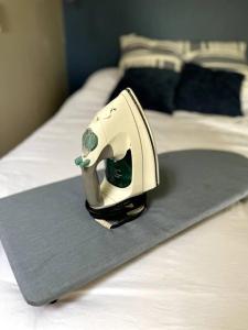 a iron is sitting on top of a bed at Affordable & Chic RiNo/LoDo/Dtown Loft- Walkable in Denver