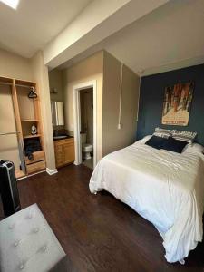Schlafzimmer mit einem großen weißen Bett und blauen Wänden in der Unterkunft Affordable & Chic RiNo/LoDo/Dtown Loft- Walkable in Denver