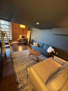 a living room with a couch and a table at Affordable & Chic RiNo/LoDo/Dtown Loft- Walkable in Denver