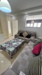 a living room with a bed and a couch at Bonito apartamento en Barrio Calvo Sotelo in Melilla
