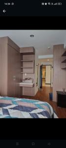 a bedroom with a bed and a wooden cabinet at Niar P in Sunggal