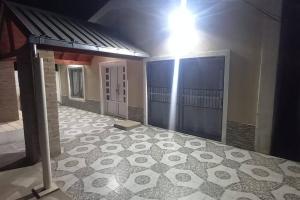 an empty room with a tile floor and a building at el quincho in Mercedes