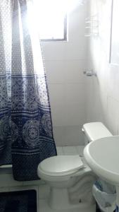 a bathroom with a toilet and a shower curtain at Errol and Nancys place in Stapleton Gardens