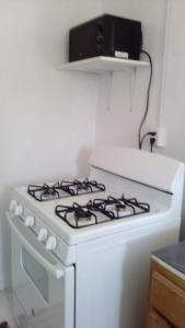 a white stove top oven in a kitchen at Errol and Nancys place in Stapleton Gardens