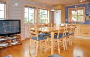 a dining room with a wooden table and chairs at Lovely Apartment In Slen With House A Panoramic View in Sälen
