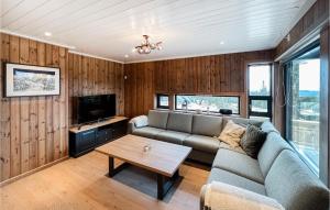 a living room with a couch and a table at Cozy Home In Sjusjen With Kitchen in Sjusjøen