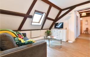 a living room with a couch and a table at Amazing Apartment In Rouffach With 2 Bedrooms And Wifi in Rouffach