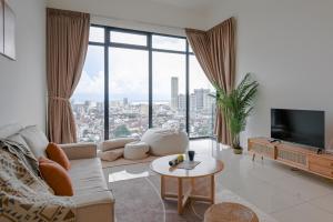 a living room with a couch and a large window at Beacon Executive Suites in George Town