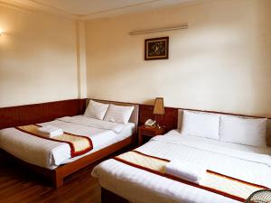 Postel nebo postele na pokoji v ubytování ANH ĐÀO HOTEL