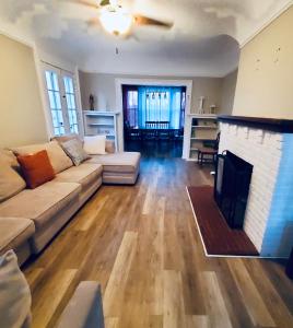 a living room with a couch and a fireplace at Rustic Colonial Home with Private Rooms in Waterbury