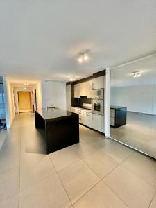 a large kitchen with a black island in a room at Spa luxury app for 2 or 4 pers centre lac view in Montreux