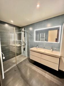 a bathroom with a shower and a sink and a mirror at Spa luxury app for 2 or 4 pers centre lac view in Montreux