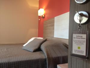 Postel nebo postele na pokoji v ubytování LOGIS Hotel Restaurant Auberge Du Cheval Blanc