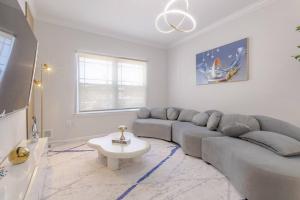 a living room with a gray couch and a table at Beautiful 3bedroom apartment in Elizabeth