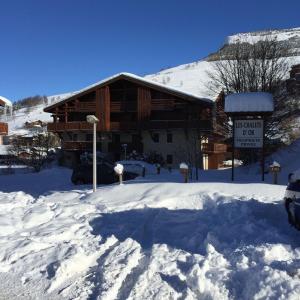 a ski lodge with a pile of snow in front of it at Résidence Chalet d'Or by Leavetown Vacations in Les Deux Alpes