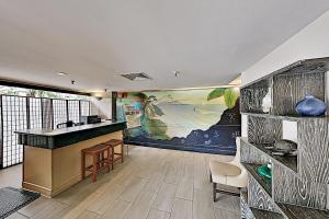 a lobby with a bar and a painting on the wall at Elegant & Elevated Palms Studio condo in Honolulu