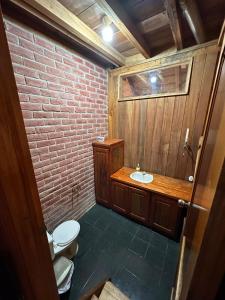 a bathroom with a toilet and a sink at TONYs HOUSE MINDO in Mindo