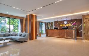 a living room with a couch and a table at Nesta Hotel & Spa in Hanoi