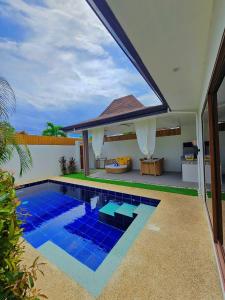 a swimming pool in the backyard of a house at Bali Villas Panglao Bohol in Panglao