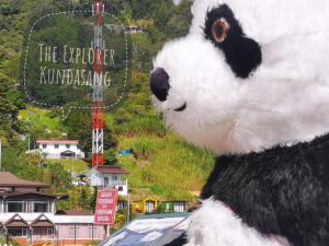 a large stuffed panda bear sitting on top of a building at The Explorer Kundasang in Kundasang