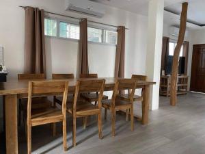 ein Esszimmer mit einem Holztisch und Stühlen in der Unterkunft Brand New Home in Cebu City with 3 Large Bedrooms! in Cebu City