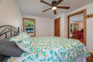 a bedroom with a bed and a ceiling fan at Relaxing Lakeside Retreat in Rhinelander