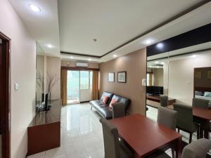 ein Wohnzimmer mit einem Sofa und einem Tisch in der Unterkunft Super Studio Galeri Ciumbuleuit 1 (1BR, 1BA, Kitchen) in Bandung