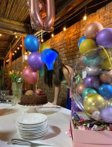 a table with a bunch of balloons and a cake at Casa en San Fernando Pachacamac in Lima
