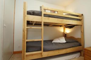 a couple of bunk beds in a room at Résidence Chalet d'Or by Leavetown Vacations in Les Deux Alpes