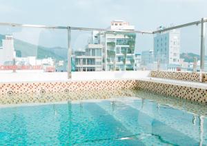 a swimming pool on the roof of a building at Dezon Hotel in Quy Nhon