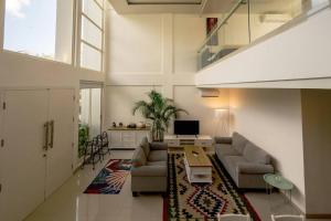 a living room with a couch and a tv at The View Villa 2 - 2br Minimalist Villa in Uluwatu in Uluwatu