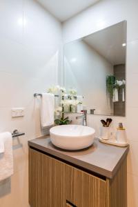 a bathroom with a sink and a mirror at Ishtar Apartment 1 Luxury Living Accommodation in Huskisson