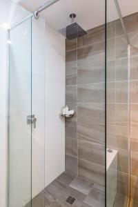 a shower with a glass door in a bathroom at Ishtar Apartment 1 Luxury Living Accommodation in Huskisson +9 photos