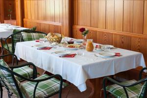 a table with a white table cloth on it at Farm Stay Kramer in Bistrica ob Sotli