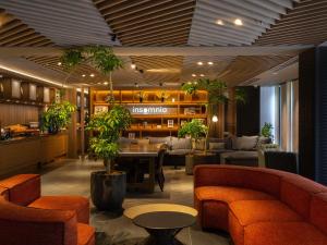 京都insomnia KYOTO OIKE的大堂设有桌椅和植物