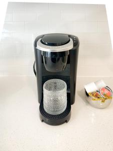 a black coffee maker sitting on a counter at Brand New Modern Apartment in Vancouver