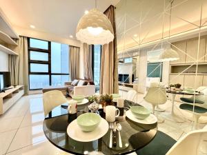 a living room with a glass table and chairs at Robertson Suites by Sleepy Bear, Bukit Bintang in Kuala Lumpur