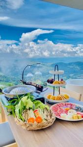 a table topped with plates of food on a table at La Villa Hill-ลาวิลล่าฮิลล์ in Mon Jam