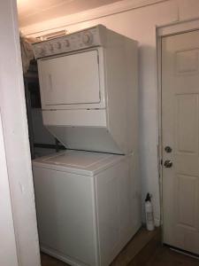 a white washer and dryer in a room at Skyline Siesta: Chic Couch Quarters in Heart of Echo Park – DTLA Awaits in Los Angeles +5 photos