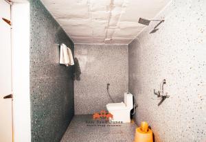 a bathroom with a sink and a toilet in a room at Sam Sand Dunes Desert Safari Camp in Jaisalmer