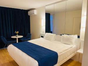 a hotel room with a large bed and a mirror at Orbi floor40 in Batumi